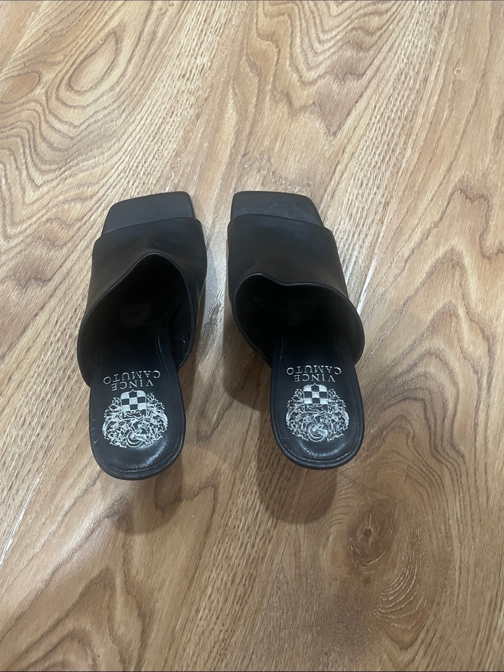 Men's footwear (slides) placed on wooden floor